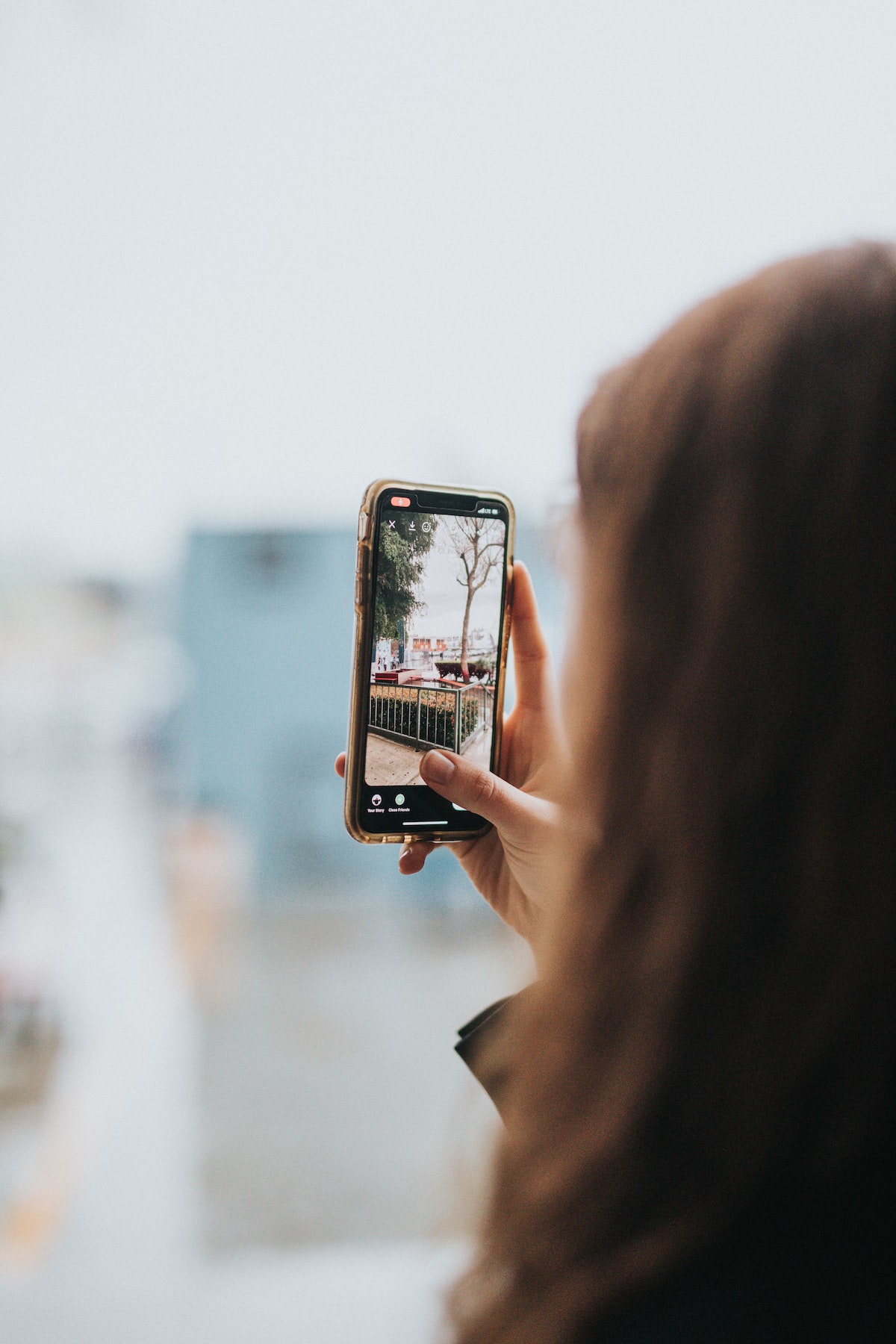 Woman taking a picture on her phone