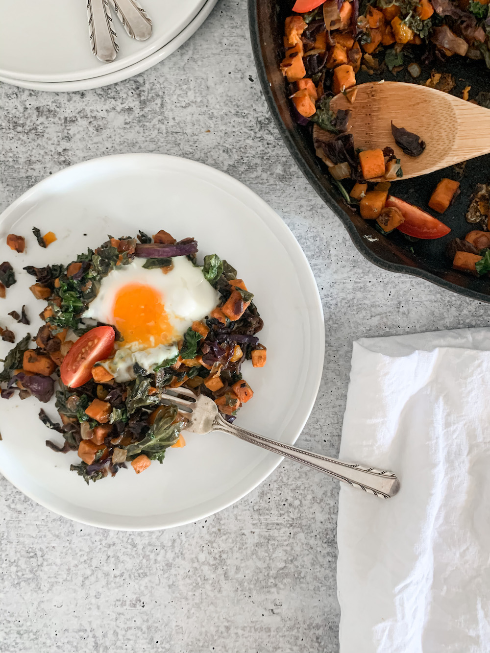 Plate of healthy breakfast hash with egg on top