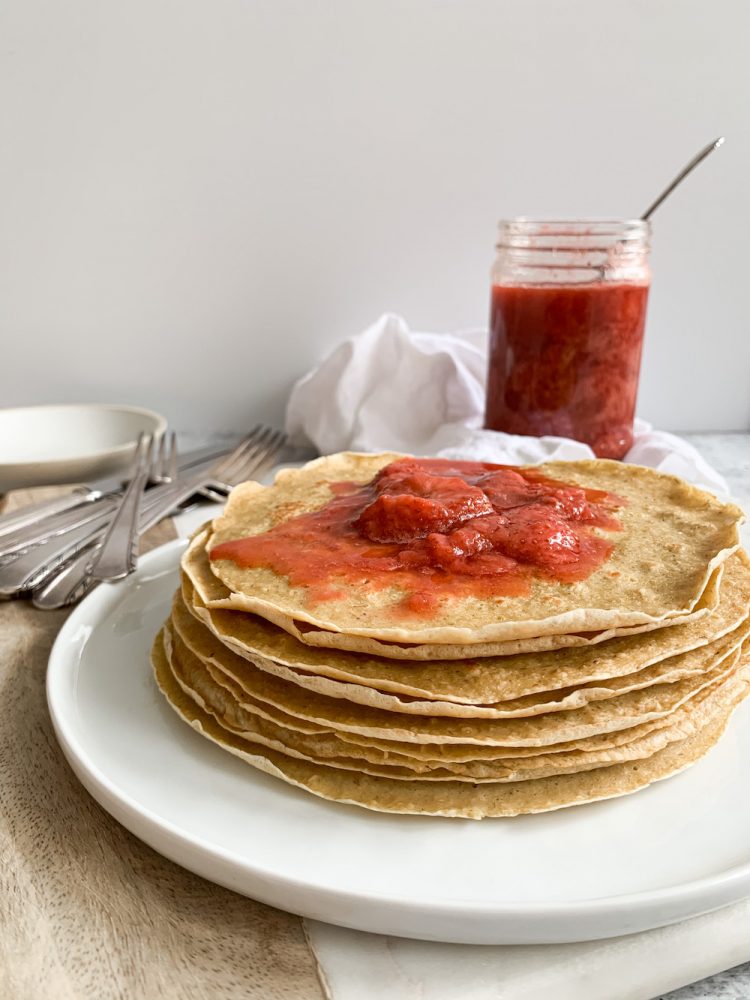 Stack of gluten-free dairy-free crepes with strawberry compote