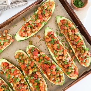 baking tray of color stuffed zucchini boat halves