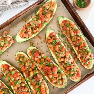 baking tray of color stuffed zucchini boat halves