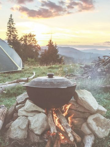 cast iron pot over a campfire