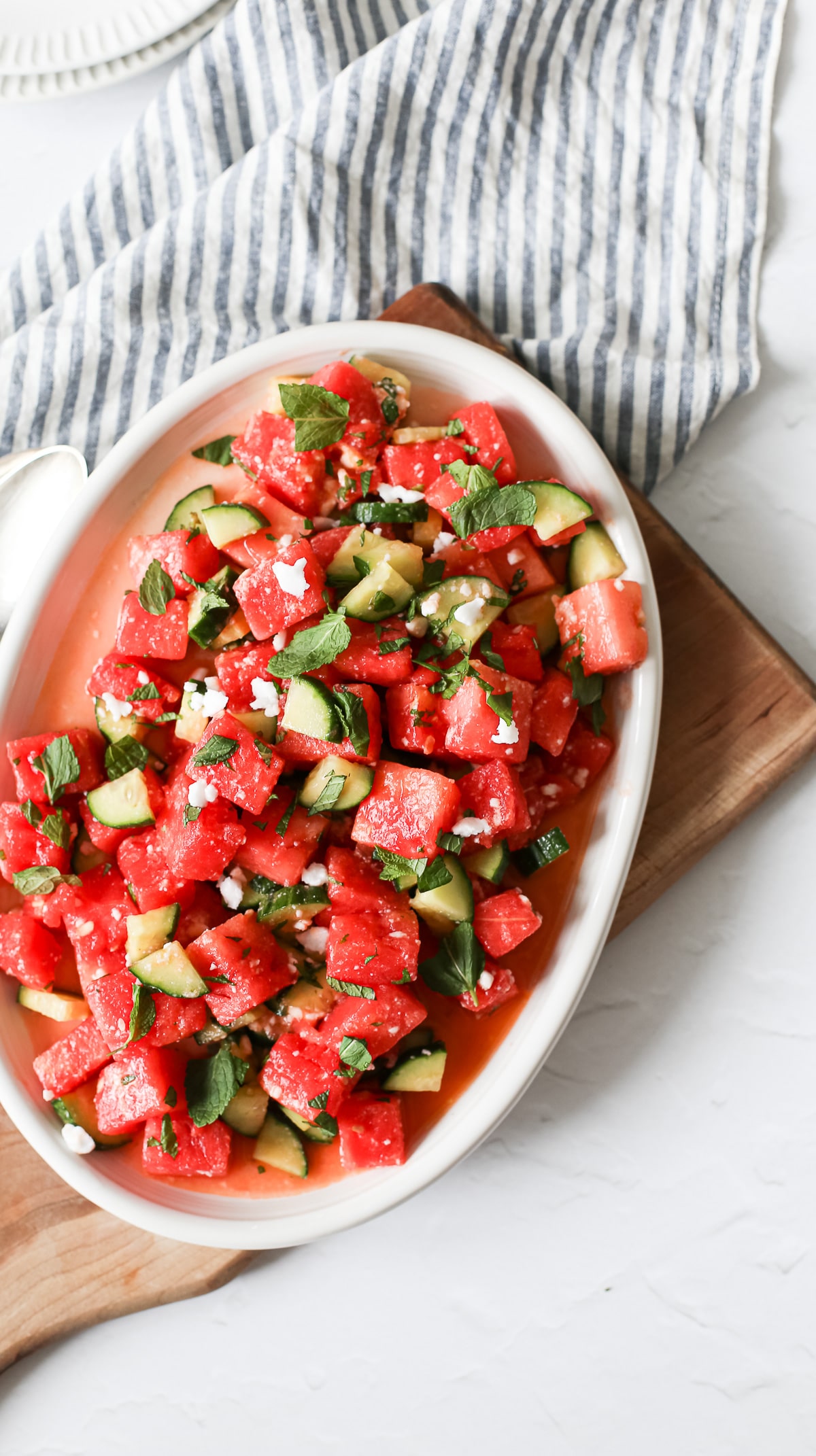 Fresh watermelon basil salad with feta and cucumber slices.