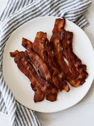 a plate of perfectly cooked oven bacon