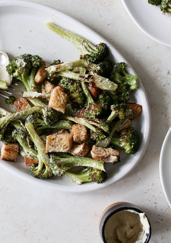 serving platter of roasted broccoli caesar salad tossed with creamy dairy-free dressing