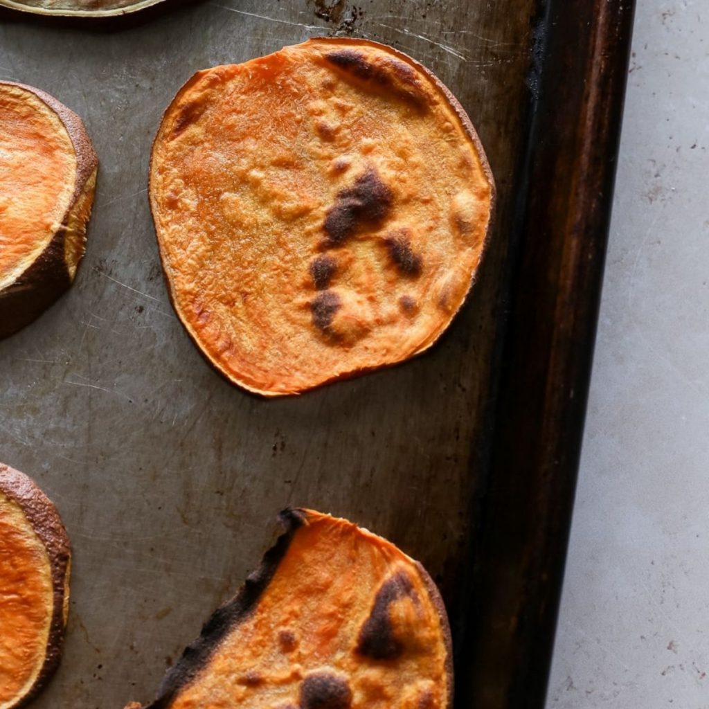 Browned sweet potato toasts on a baking sheet.