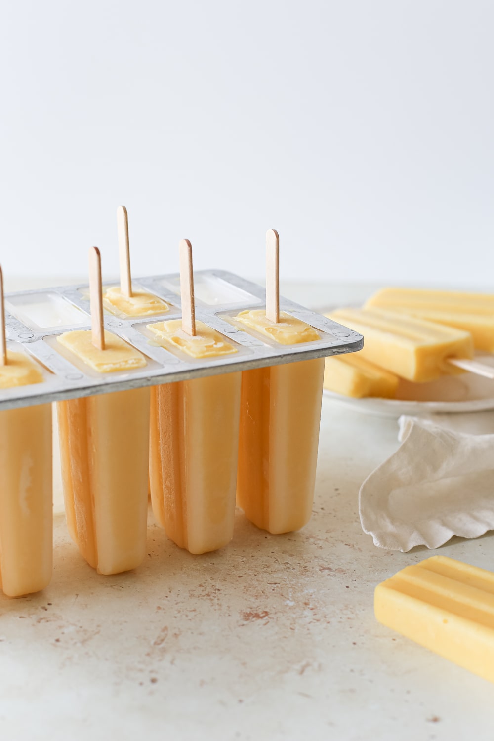 Frozen mango pineapple popsicles.