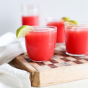 Several glasses of fresh watermelon juice served on ice.