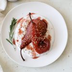 Hibiscus poached pears on a bed of yogurt with a side of fresh rosemary.