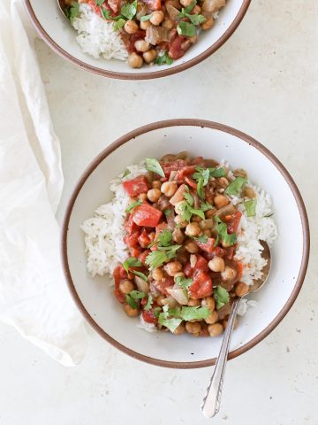 Chick pea curry with coconut milk and cilantro on a bed of rice.
