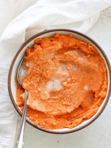 A large bowl of vegan mashed orange sweet potatoes.